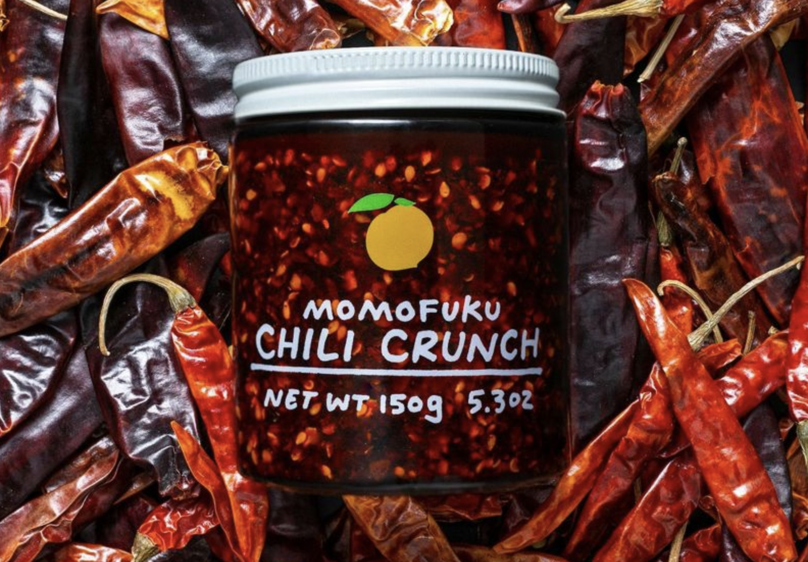 jar of momofuku chili crunch on bed of dried chili peppers