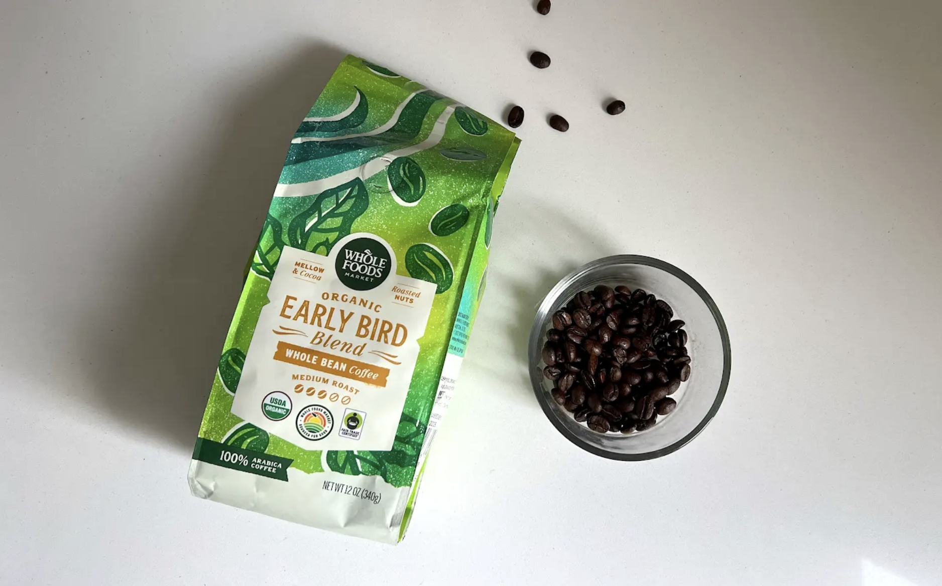 bag whole foods early bird lies next to dish of beans