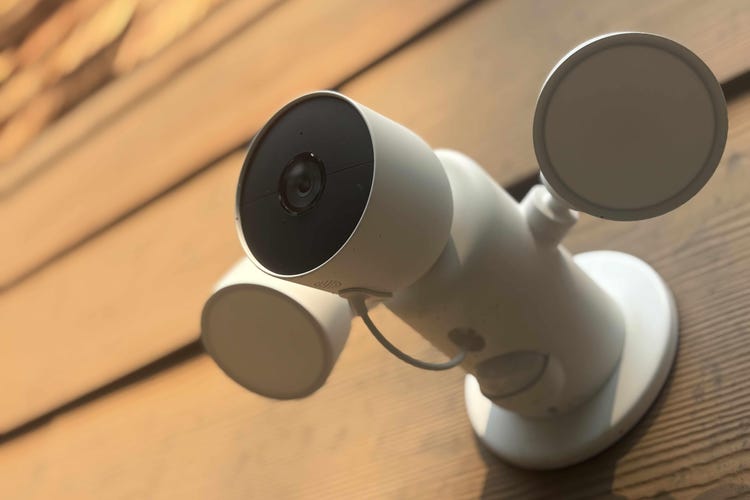 A Nest Cam Floodlight model on a brown exterior wall.