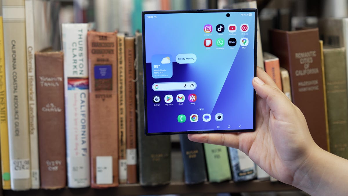 A hand holds an unfolded Galaxy Z Fold 7