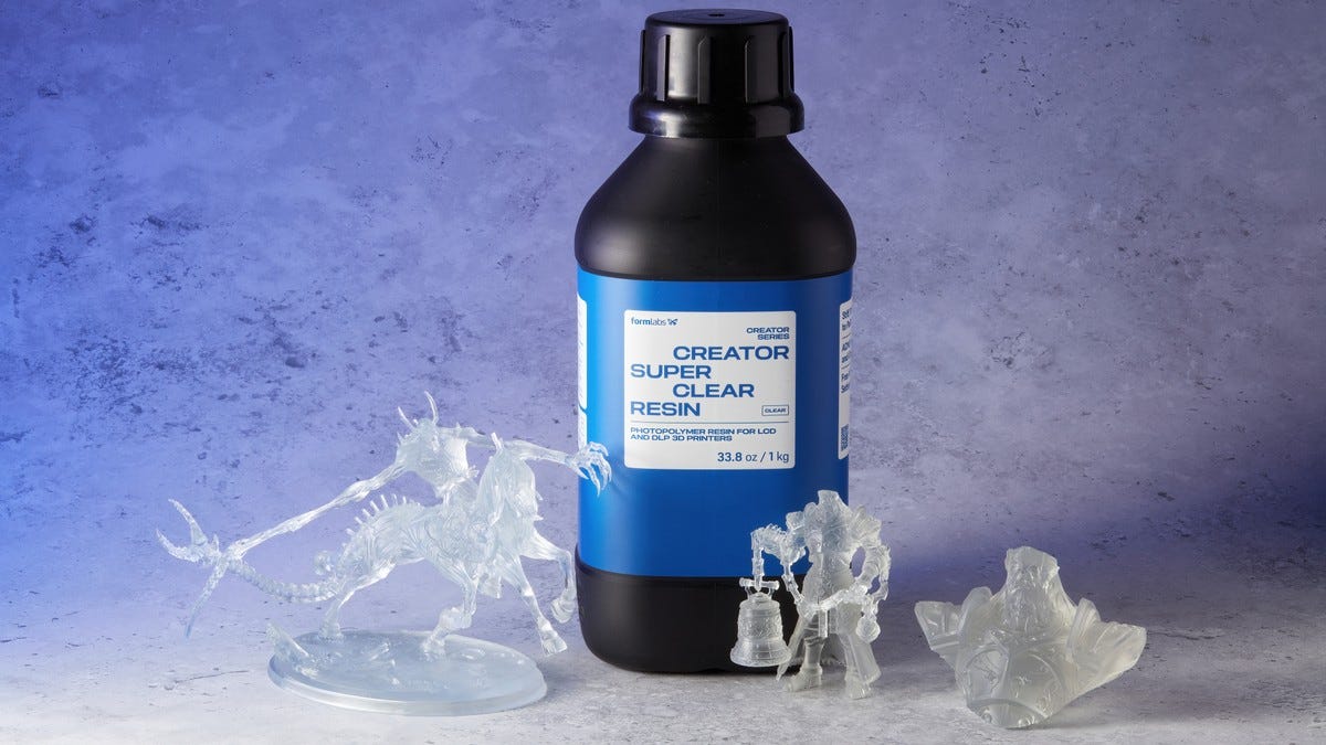 A black bottle of resin with clear models in front of it