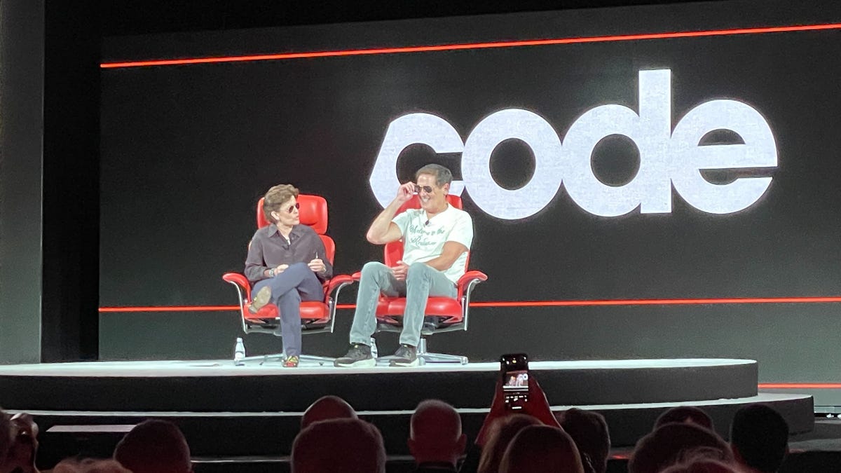 Kara Swisher and Mark Cuban sit in the Code Conference's iconic red chairs on stage as they chat.