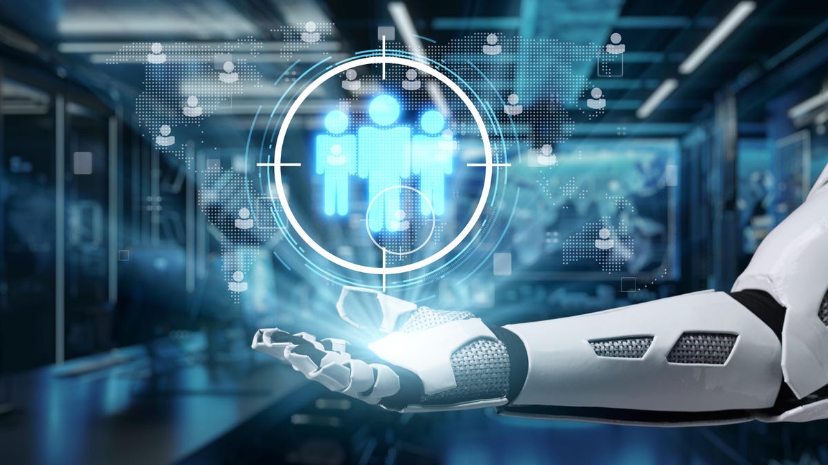 A robot hand holds an image of three human shapes.