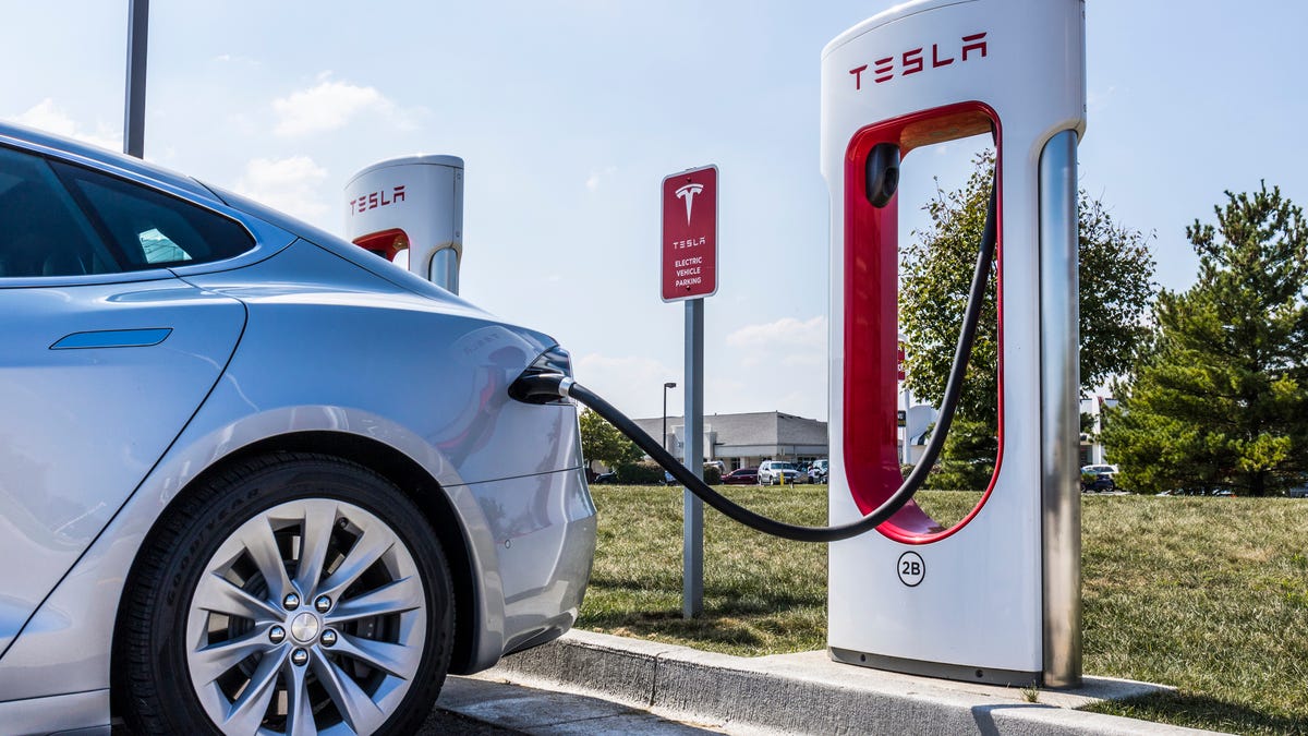 Car charging at Tesla Supercharger station