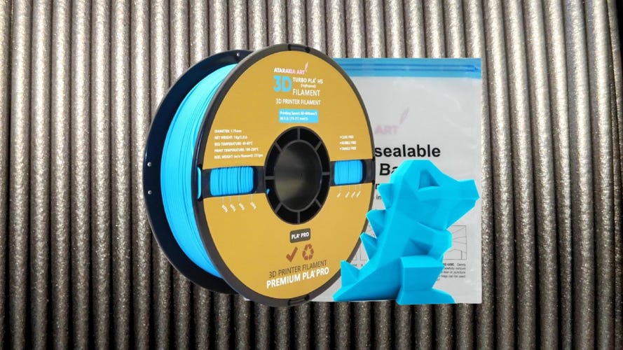 Blue roll of filament on a silver/black background