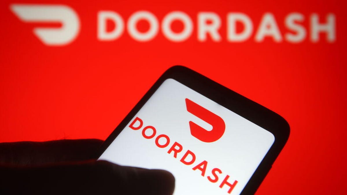 DoorDash logo is shown on a phone and a backdrop