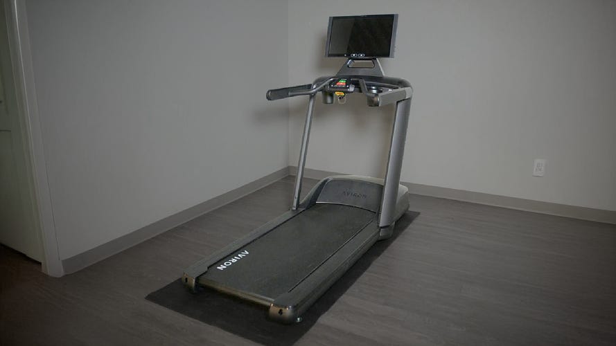 Aviron Victory Treadmill in a gray room
