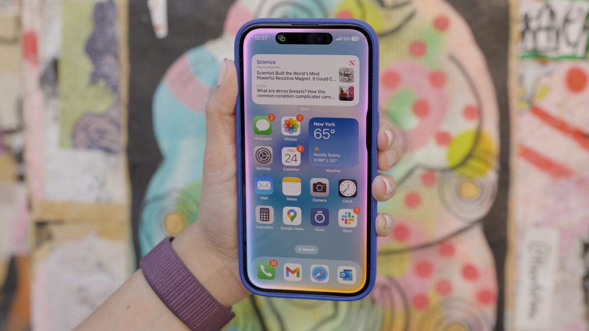 A person's hand holding up an iPhone