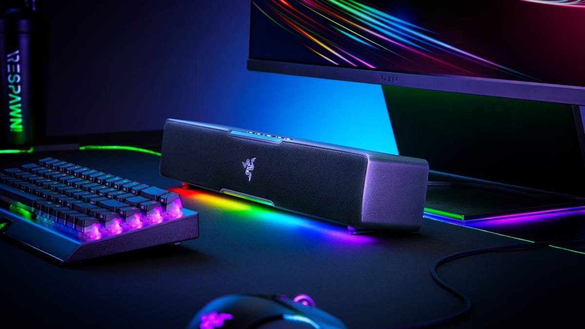 Razer Leviathan V2 X soundbar next to a chunky keyboard, a mouse and a monitor