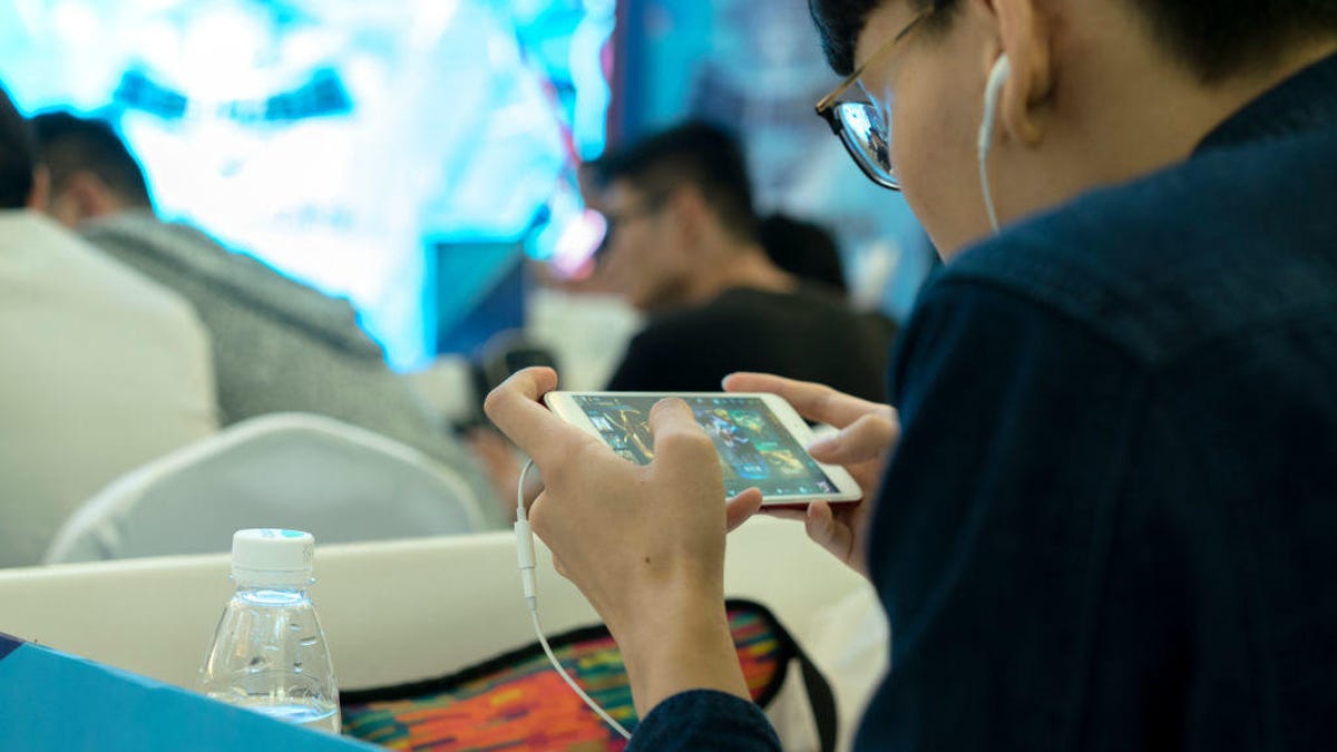 Young players compete in a battle match of the mobile game