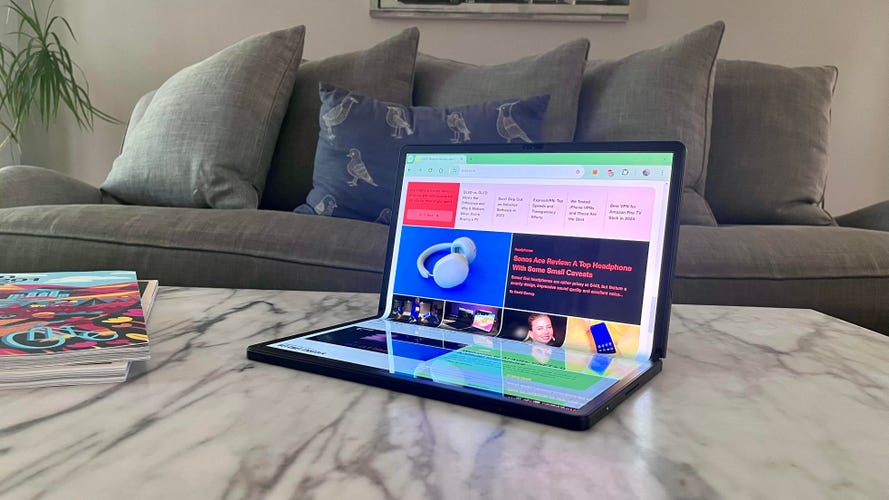 Lenovo ThinkPad X1 Fold 16 on a coffee table in front of a sofa
