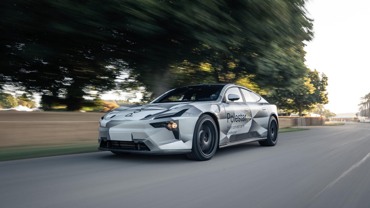 A camouflaged Polestar 5 EV prototype in motion at Goodwood Festival of Speed