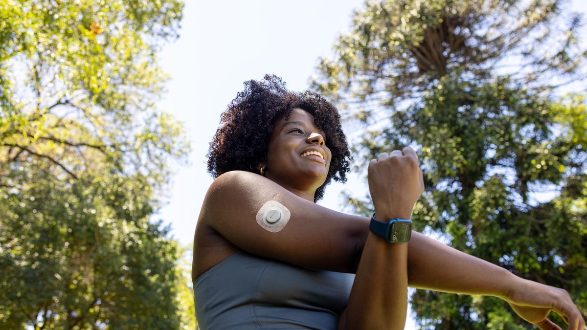 A woman wearing a Dexcom G7 and Apple Watch