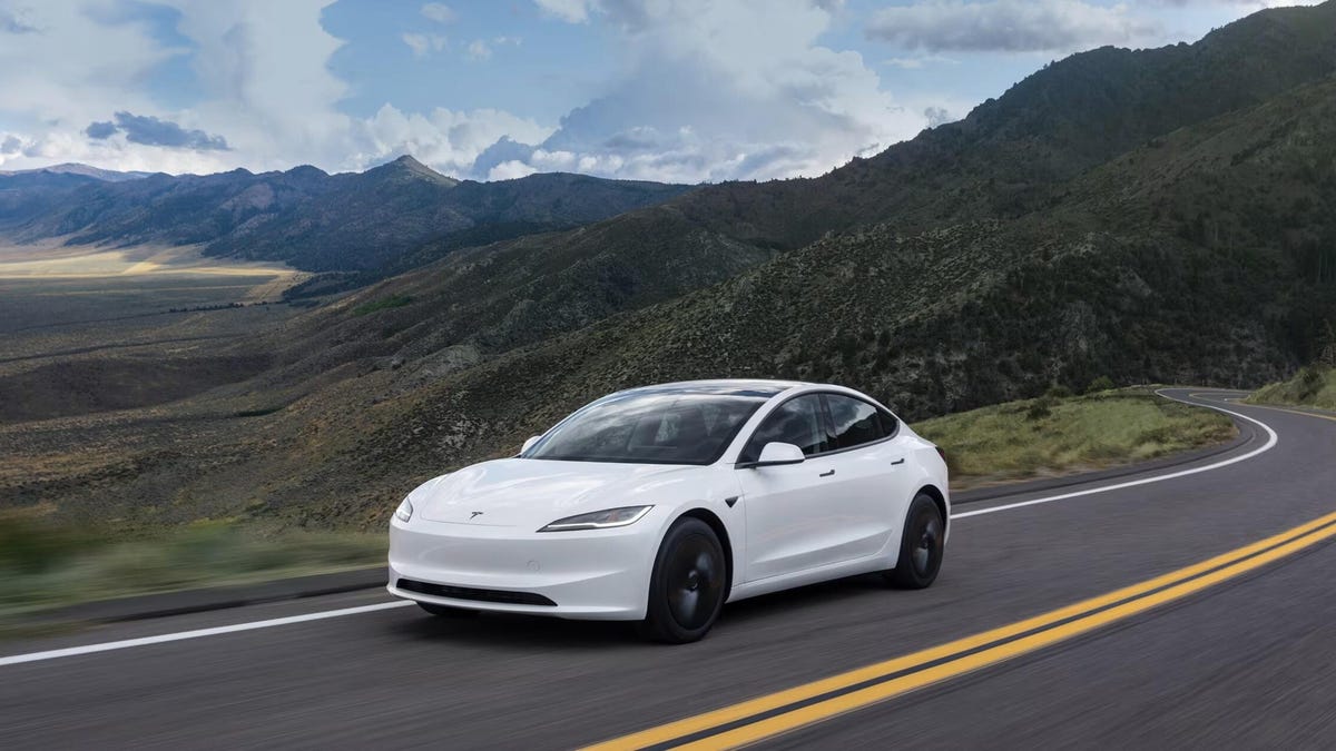 The front of a Tesla Model 3 Standard driving along a road