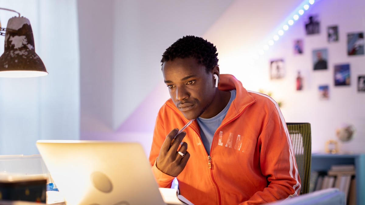 An image of a man looking at his laptop screen gettyimages-1356514812