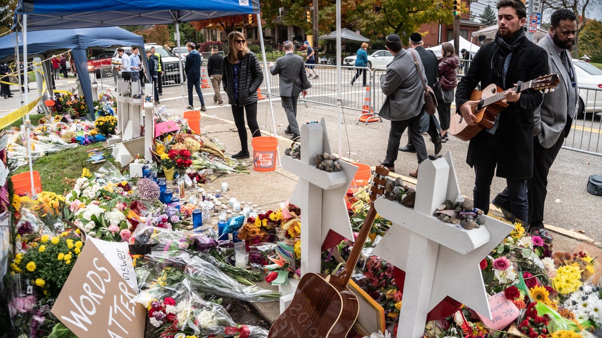 A guitarist stood passionately singing for hours.Outside