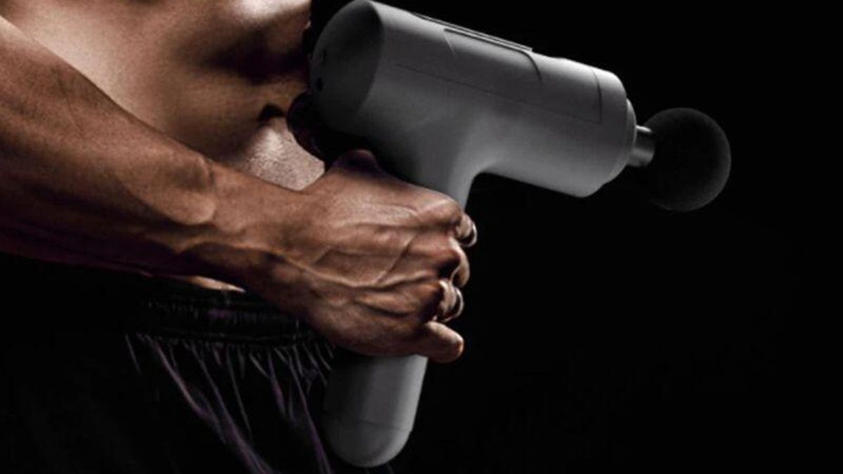 Man holding massage gun