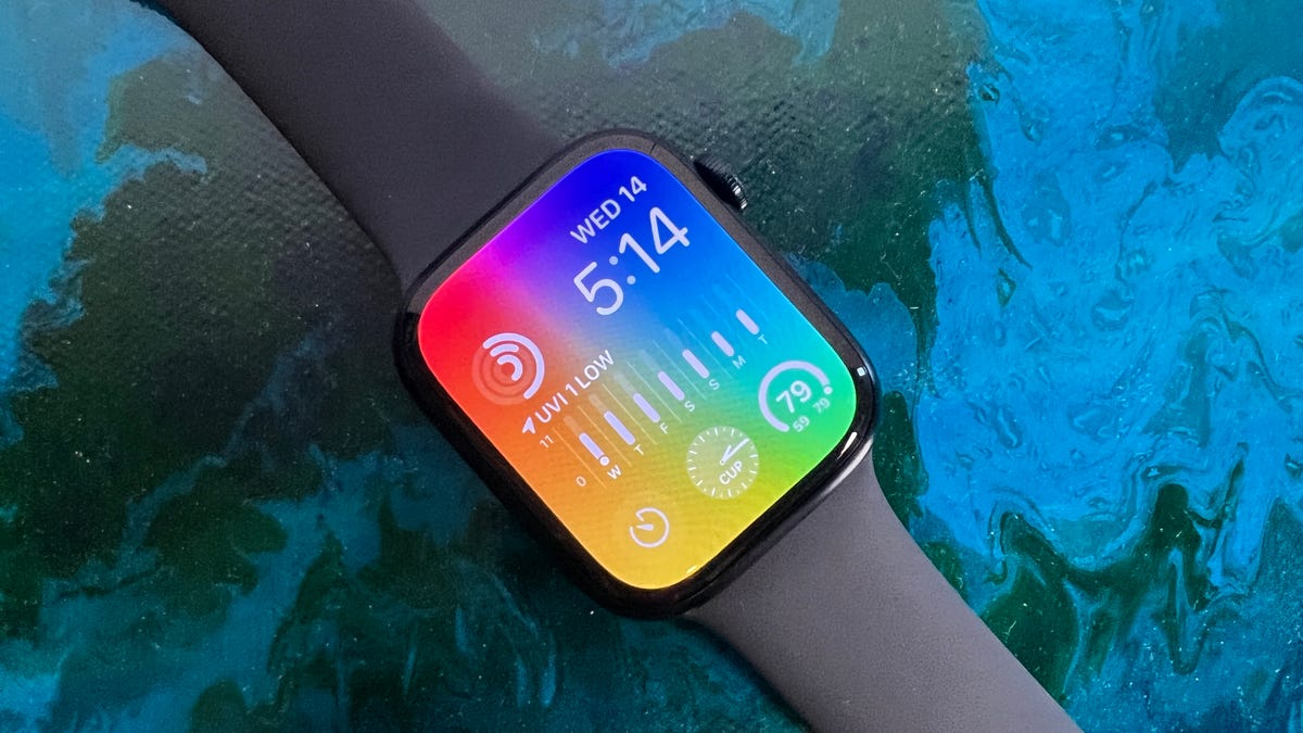 Apple Watch Series 8 with rainbow display on blue background