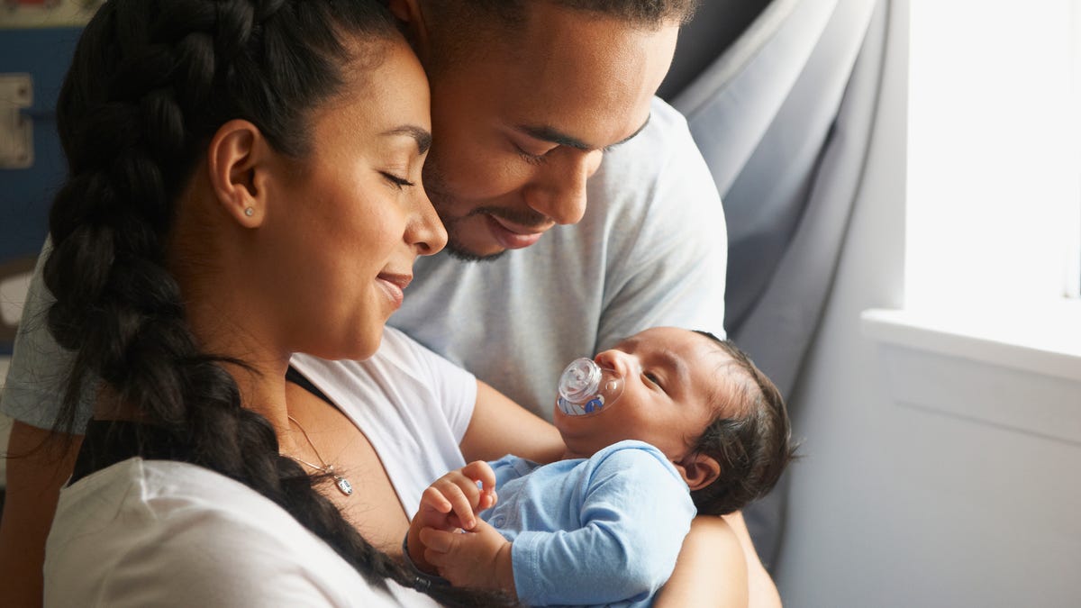 Parents holding a newborn baby
