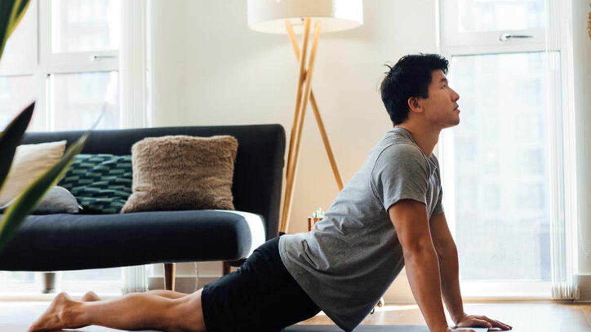 Young man in the Cobra yoga pose