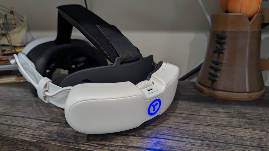 A battery head strap for the Meta Quest 3 with a glowing blue Y on the back.