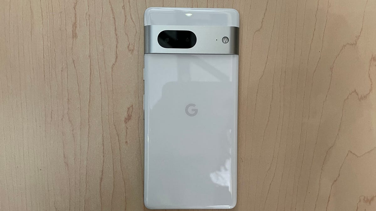 Google Pixel 7 in white on a wooden backdrop