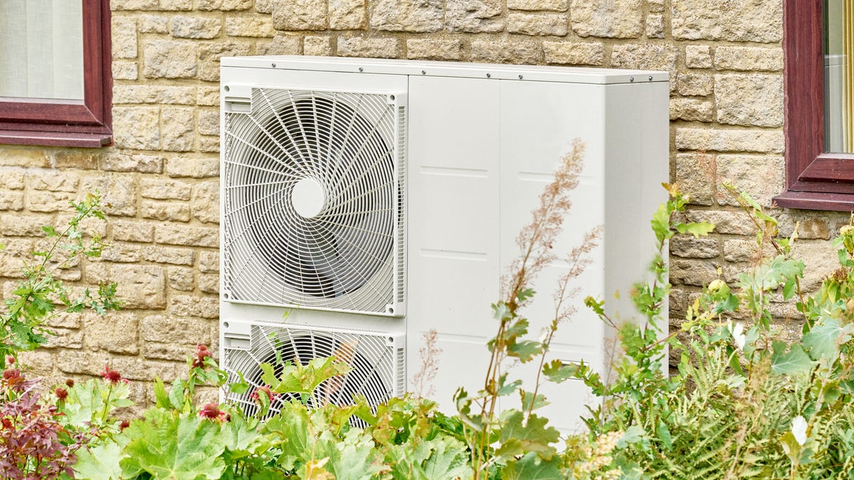 a heat pump installed on the exterior of a brick home