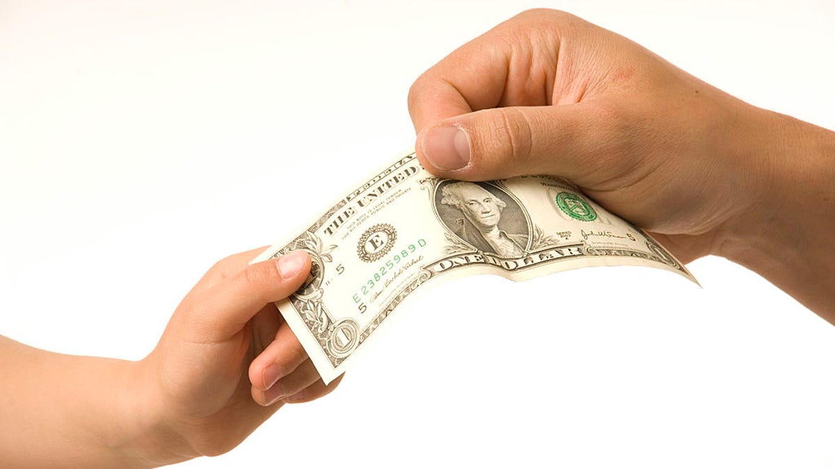 Adult giving child money gift