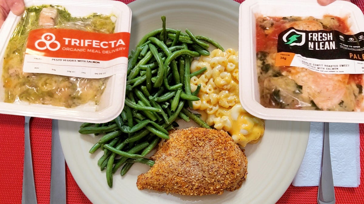 packaged premade meals next to plate of food