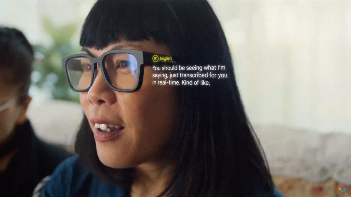 A screenshot of Asian worman wearing Google's AR glasses with translated text superimposed over it.