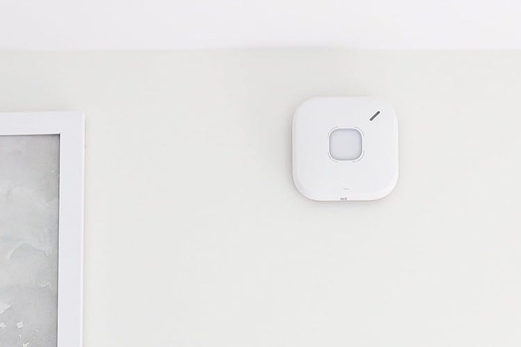 A First Alert CO detector on a white wall.