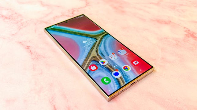 The Samsung Galaxy S24 Ultra from an angle on a pink marble surface