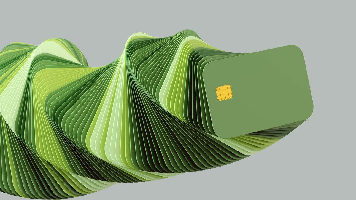 A spiral of green credit cards on a gray background.