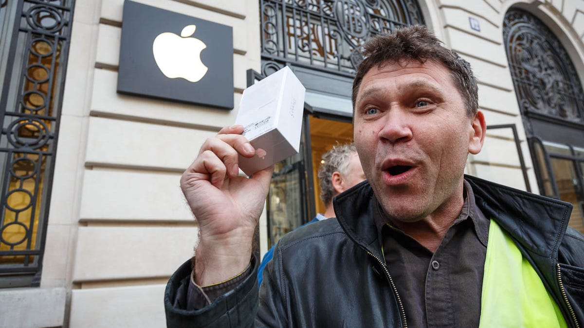 Mikhail Vorobyev, one of the early customers to buy an iPhone 5 at Apple's store in Paris, shows off his new purchase.
