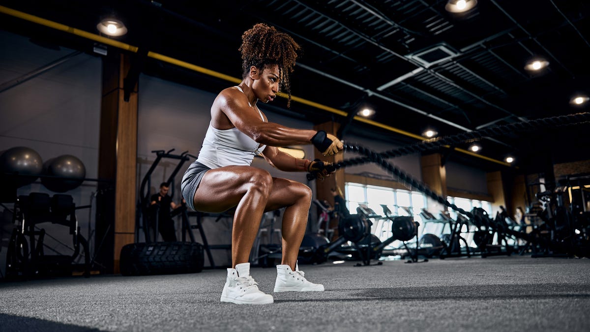 A woman doing leg squats at a gym.