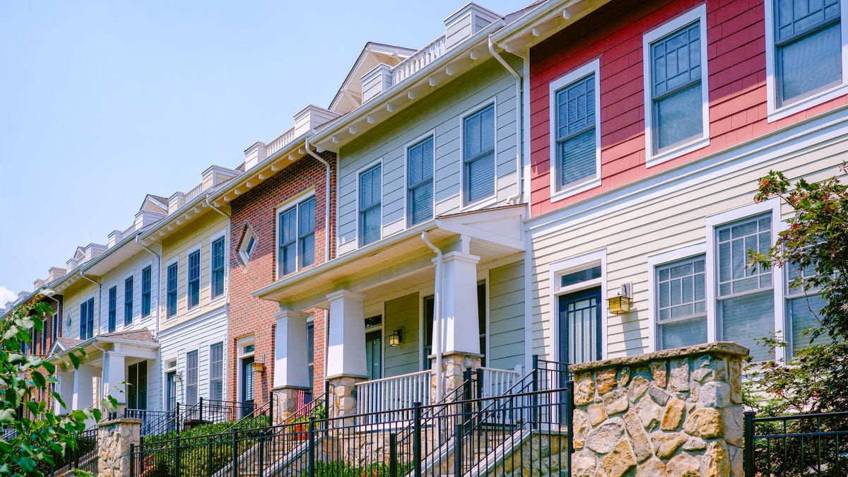 A diagonal view of multiple-colored row houses.