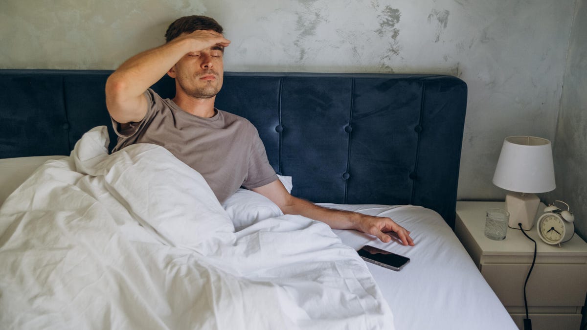 Man in bed with a bad mood.