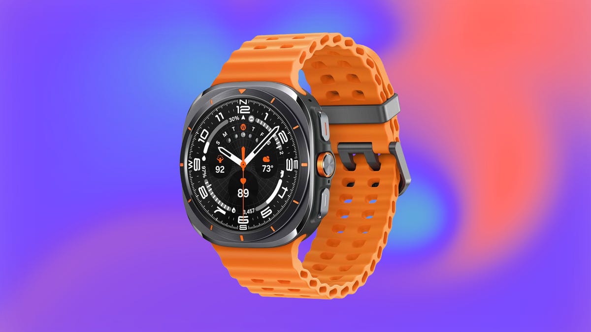 The Samsung Galaxy Watch with a bright orange band on an orange and purple background
