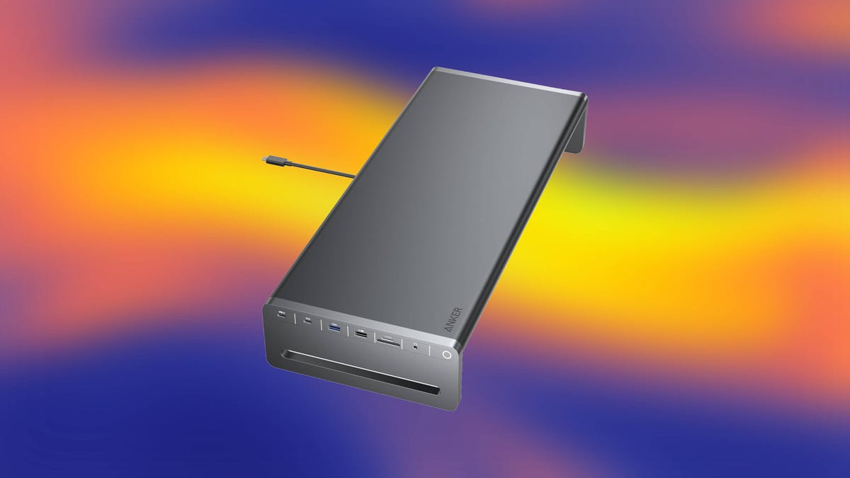 A gray Anker USB-C hub against an abstract blue and orange background.