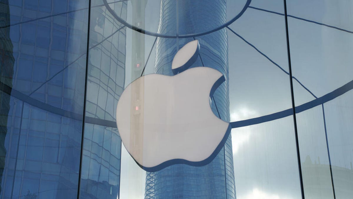 The Apple logo is shown on a store in China