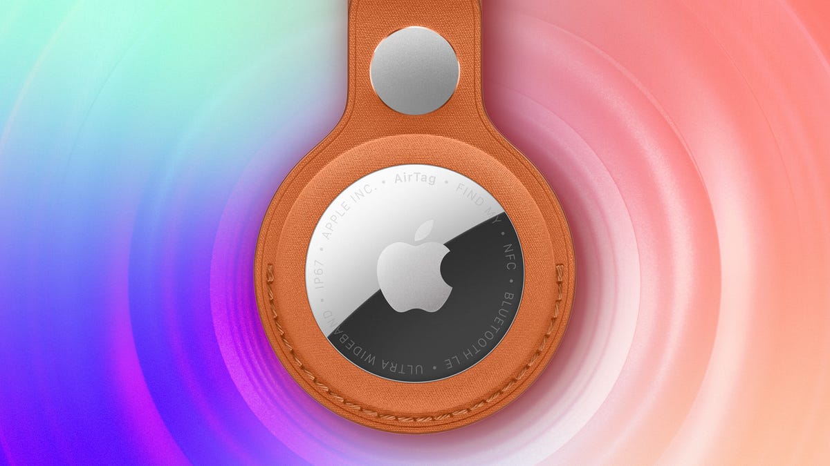 Apple AirTag in leather holder on a purple and peach background