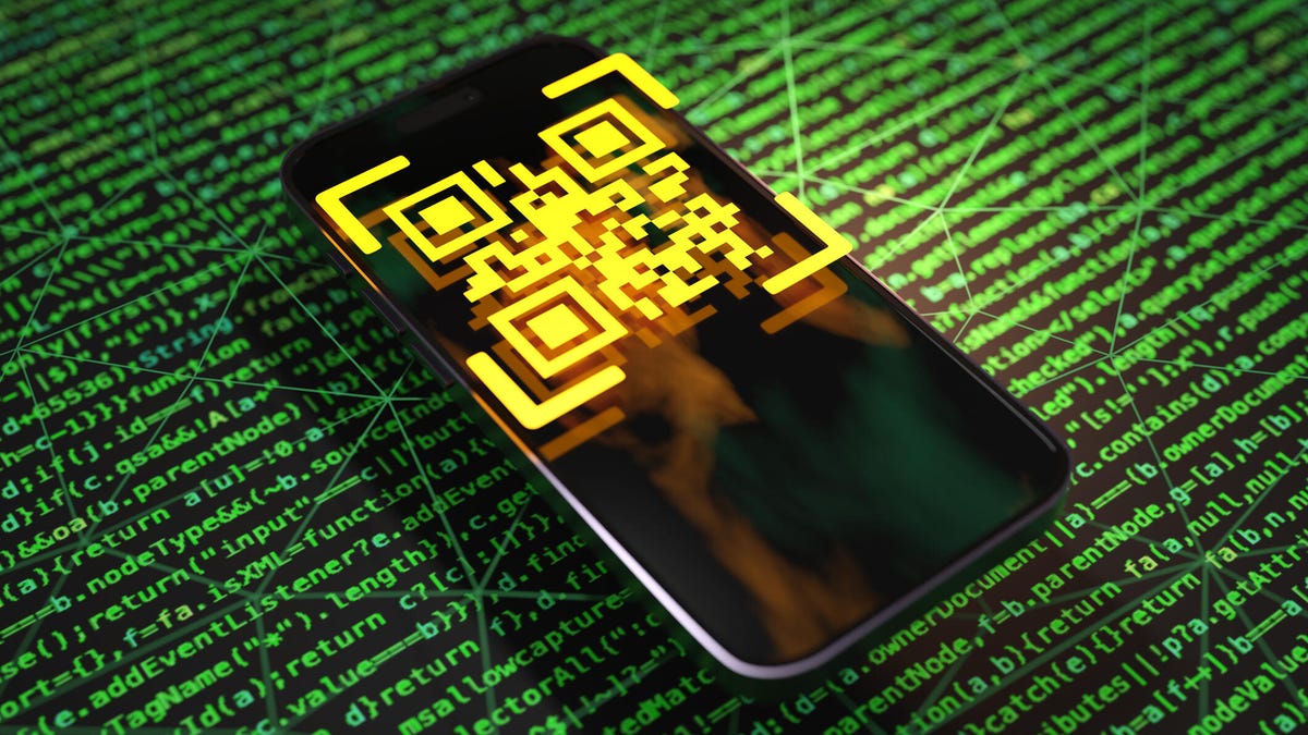 A QR code on a phone against a green background made up of code.