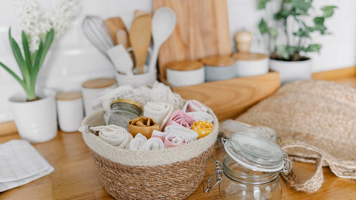 Basket with eco friendly bags lying on kitchen counter