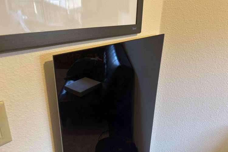 Black radiant heater on a white wall.