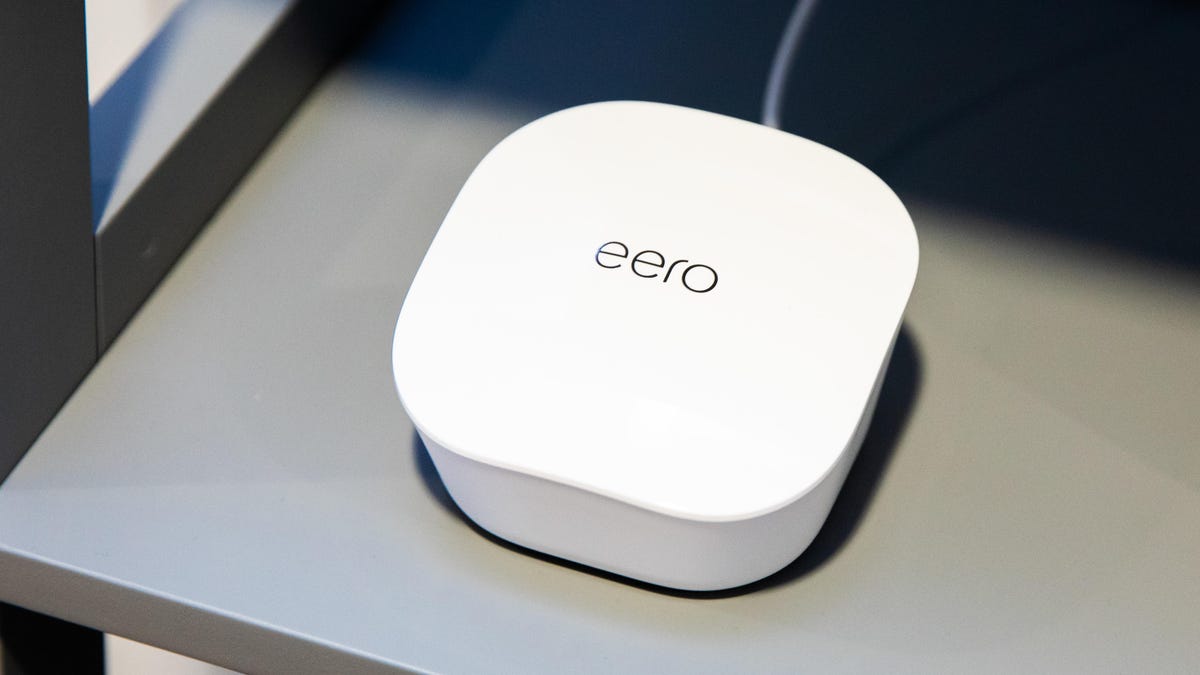 a white Eero router on a metal table
