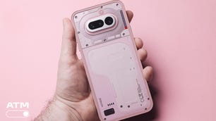 Image of a pink phone being held in the hand
