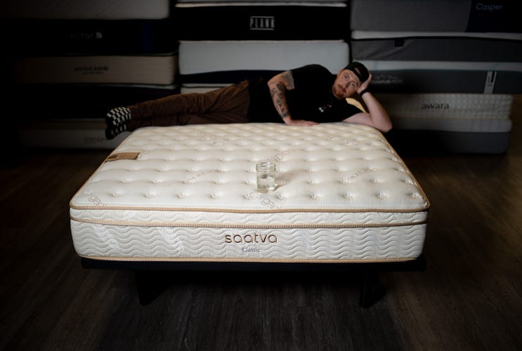 CNET's Dillon Lopez testing Saatva Classic's motion isolation