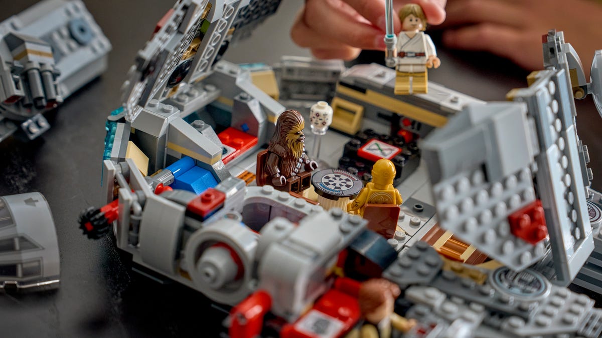 Chewbacca and C-3PO and Luke Skywalker minifigures on a Lego Millennium Falcon playset