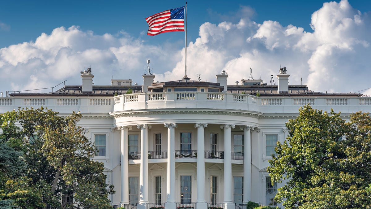 The South Portico side of the White House, with the American flag flying on the roof