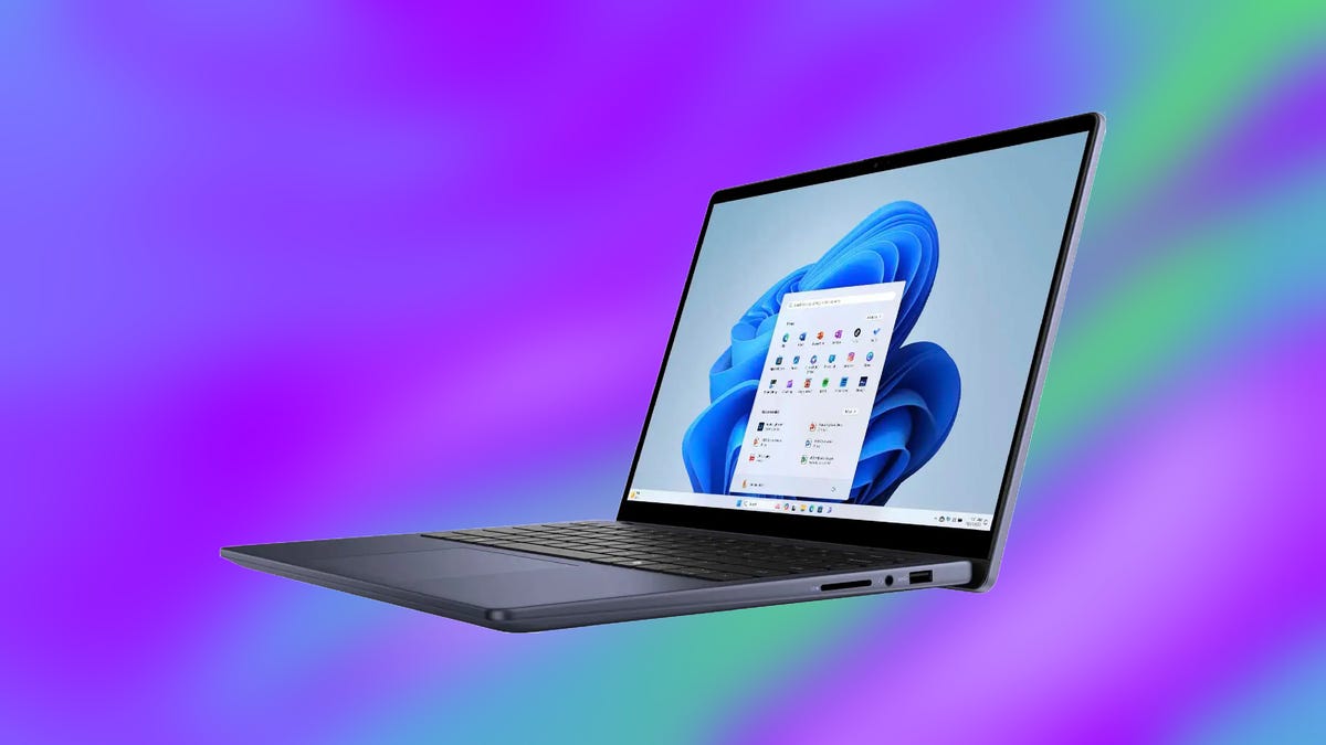 Dell Inspiron 14 laptop on purple/green background